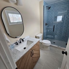 Full gut bathroom remodel. Custom vanity with glass tile shower.