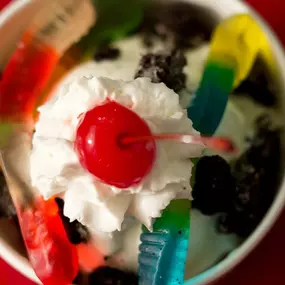 Cup of Frozen Custard with Gummy Worms, Whipped Cream, and Cherry on top