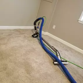 Technician extracting deep soil from residential carpet fibers during hot water clean in Bethesda MD