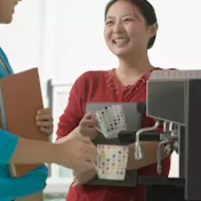 Employees enjoy coffee machine in break room