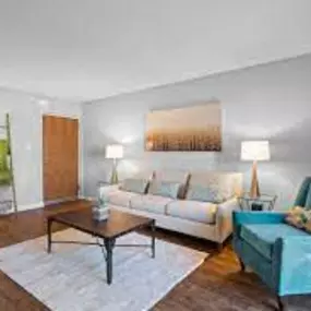 A living room with hardwood-style flooring at New Kent Apartments.