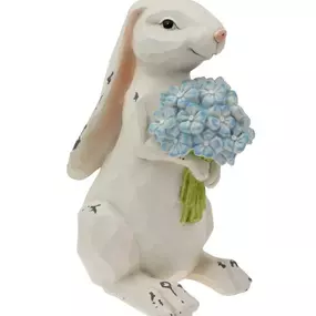 Spring into the Easter season with Nibbles Bunny, standing at a hopping 10 inches tall! This charming decorative piece holds a blue hydrangea in its paws, adding a touch of whimsy to your space. With dimensions of 6 x 5 x 10 inches, it's a perfect fit for any Easter arrangement. (And no need to fret, this bunny is more of a flower admirer than a nibbler!