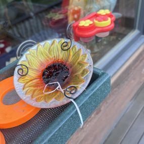 This is something I have observed over the last few years. My Orioles leave nesting material in the jelly!! In one of my other feeders, I keep finding horse hair and in this feeder they left a piece of string/fabric!! Quirky birds they are!!