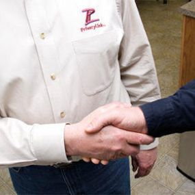 PrivacyLink team member shaking hand with business partner