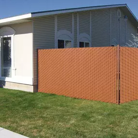 Chain link fence privacy slats in front yard of home