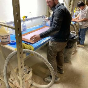 N-Hance Wood Refinishing of Chicago technician working on cabinet painting in Des Plaines facility