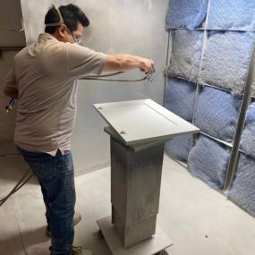 N-Hance Wood Refinishing of Chicago technician working on cabinet painting in Des Plaines facility