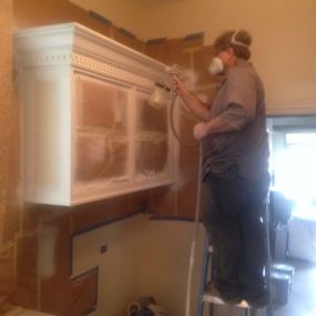 N-Hance Wood Refinishing of Chicago technician working on cabinet painting in Hinsdale, IL home