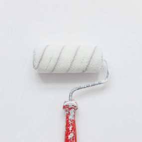 white paintbrush with red handle