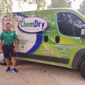 Elmer standing next to green cleaning van