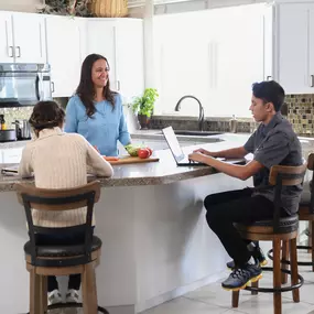 family hanging out in their kitchen