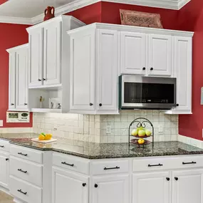 red-walled kitchen with white cabinet painting by N-Hance