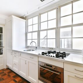 Kitchen with white painted cabinets