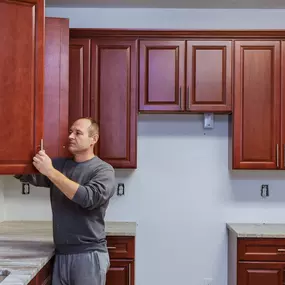 man performing a cabinet refinishing service in Charleston, SC