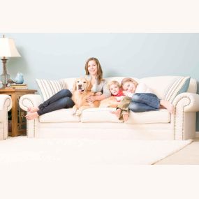Woman, kids, and dog on clean upholstery