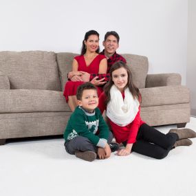 Family sitting together on clean carpet during the holidays