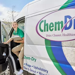 A service technician woman exiting a van