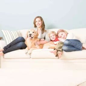 Woman, kids, and dog on clean upholstery