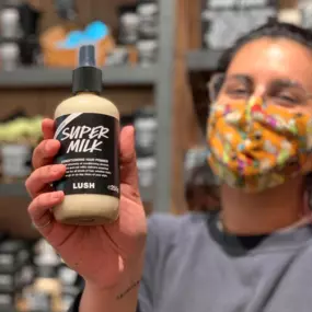 Staff member holding hair primer Supermilk