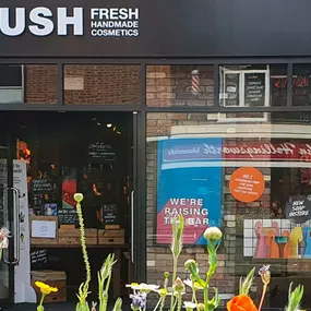 Photo shows and image of the Solihull store front, with wild flowers in bloom in the foreground.