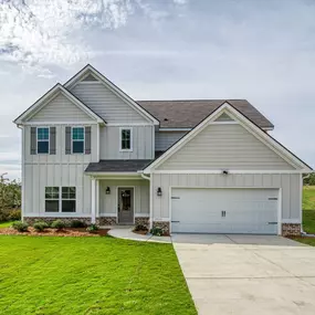 Two story home with white siding and a 2-car garage at DRB Homes Mill Pond Community