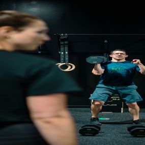 The MADabolic Difference: Instead of a cheerleader, you’ll find a qualified trainer who remembers your name. Instead of screens, simulations, or microphones, you’ll encounter 1:1 human interaction and accountability. Instead of “toning”, you’ll lift weight and build meaningful strength and muscle mass. Instead of treadmills, you’ll run on the actual ground. Instead of chasing sloppy reps, you’ll move well for an allotted period of time. Instead of chaos, you’ll find structure and purpose. Instea