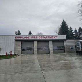 Kaizen Plumbing service truck parked outside the Kirkland Fire Department.