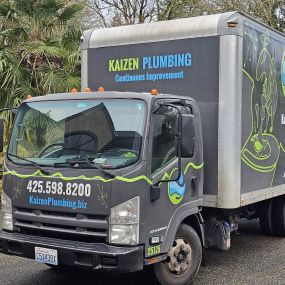 Close-up of Kaizen Plumbing truck outside a home.