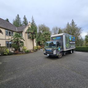 Kaizen Plumbing truck parked in front of a residential property.