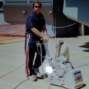 Sanding the new teak deck after installation on the 
Mighty USS North Carolina Battleship 
One proud business owner