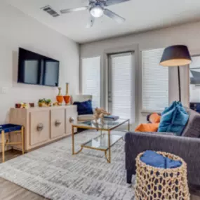 Living room with Large Windows and Wood-Style Flooring  and Ceiling Fans