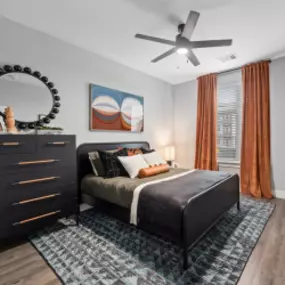 Primary Bedroom with Large Window and Hardwood-style Floors