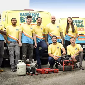 Sunny Bliss Plumbing & Air Team in front of wrapped vehicles