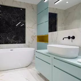 Black and white tile with a beautiful colored vanity makes for a gorgeous master bathroom!