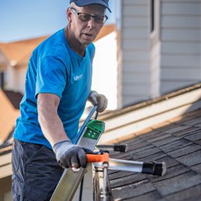 Matt is cleaning a gutter in a residential neighborhood