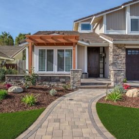 Front yard makeover including pavers, artificial turf, plants, walls and pillar, pergola and outdoor lighting