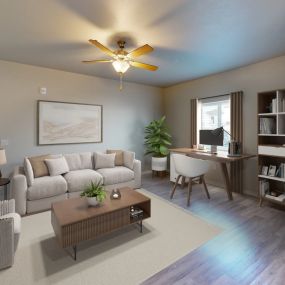 Cozy living room with a neutral couch, ceiling fan, and office set up in front of window