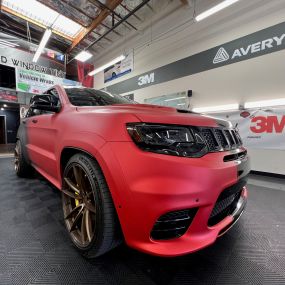 matte wrap and window tint being installed onto a jeep by Dwraps