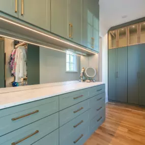 A large custom closet with hang space, drawers, shelving, and an island