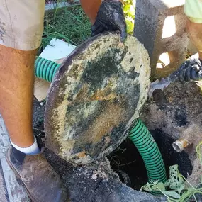 Performing a grease trap pump and water jet service at a residence in Conroe