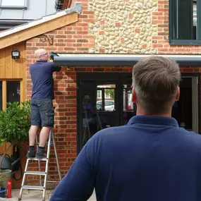 Technical manager, Matt checks that the alignment of this Fold Arm Awning, is as it should be