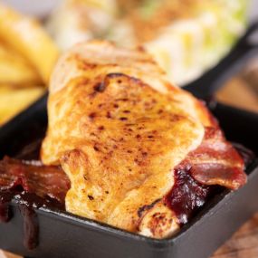 Hunter’s chicken, chargrilled chicken breast with smoked streaky bacon, melted cheese and BBQ sauce. Served with skin-on chips and dressed baby gem lettuce
