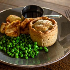 Handmade steak & ale pie, skin-on chips, peas, gravy.