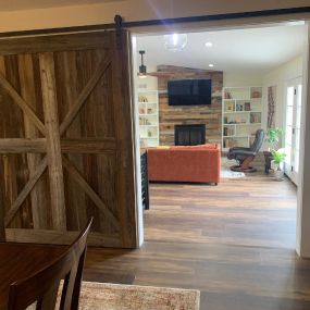 This project created a room divider adding  this custom built sliding barn door. Walking into the Den, they have chose a great selection of Barn siding for their fireplace wall and adding a one of a kind fireplace mantel to this great space!
