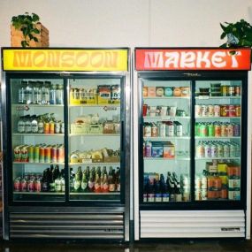 Monsoon Market Fridge Stocked with Non-Alcoholic Drinks, Beers, Drinks, Cheeses, and more.