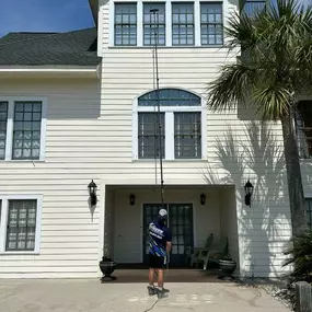 Waves Power Washing performing window cleaning in Hampstead, NC.