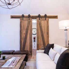 Narrow double barnwood doors crafted from reclaimed wood, offering a rustic and space-saving solution for interior design.