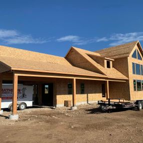 Clean construction site of new home under construction. No siding or shingles on home yet.