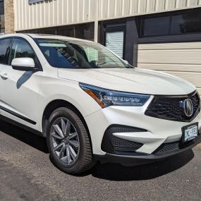 We did a Chrome Delete Vinyl Wrap on this white 2023 Acura RDX in our shop in Wheat Ridge!
