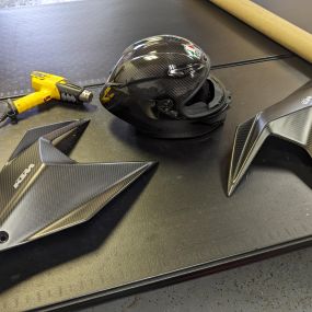 Custom clear bra work on these carbon fiber KTM bike side panels and carbon fiber helmet